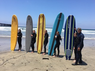 vacationers take surf lessons