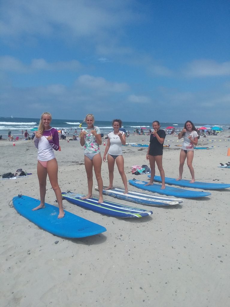 teenagers learn to surf